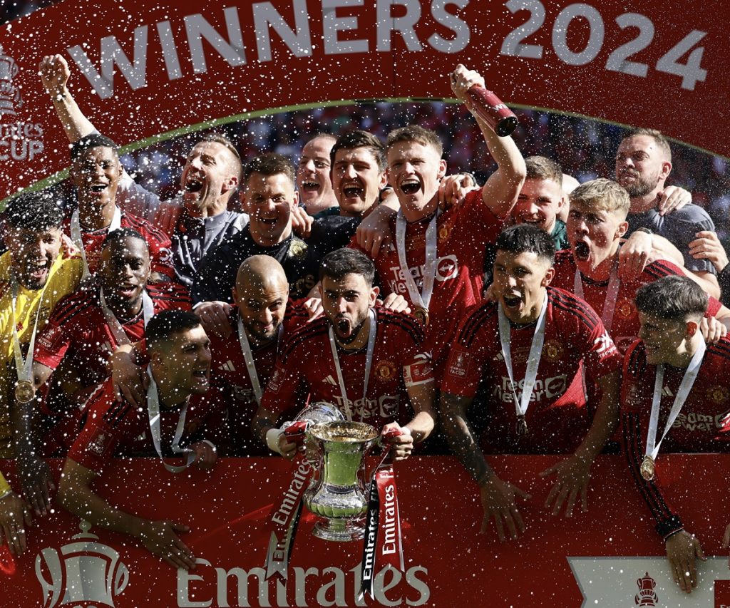 Manchester United's players celebrate with the trophy after winning the English FA Cup final match of Manchester City against Manchester United, in London.