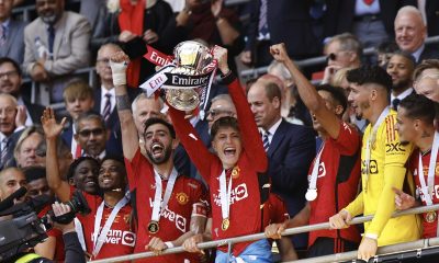 Manchester United's players celebrate with the trophy after winning the English FA Cup final match of Manchester City against Manchester United.