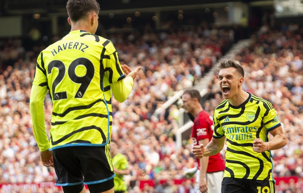 Leandro Trossard of Arsenal celebrates scoring the 0-1 goal with his teammtae Kai Havertz (L) who assisted the goal during the English Premier League soccer match between Manchester United and Arsenal in Manchester.
