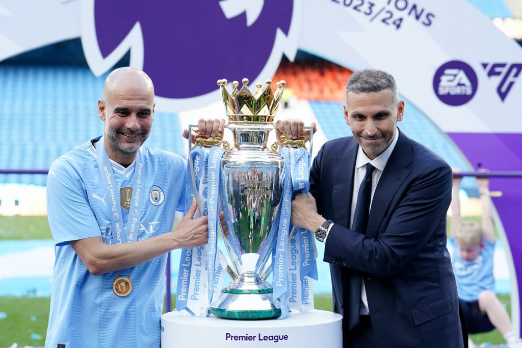 Manchester City manager Pep Guardiola (left) and club chairman Khaldoon Al Mubarak pose for a photo with the Premier League trophy after the Premier League match at the Etihad Stadium, Manchester.