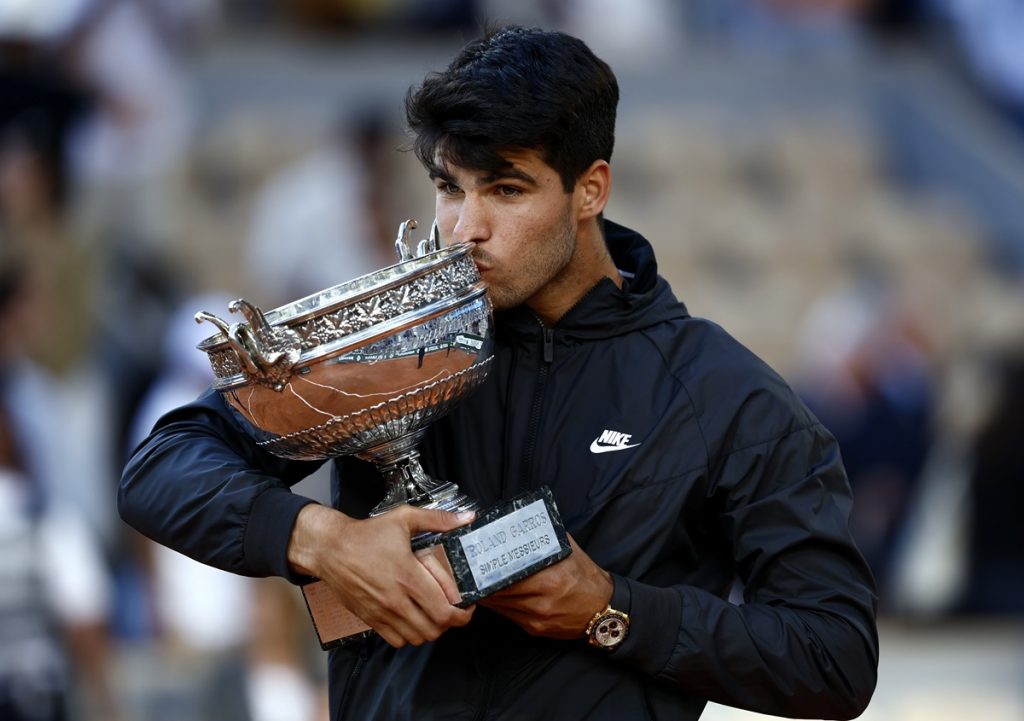 Carlos Alcaraz of Spain poses with the Coupe des Mousquetaires trophy after winning his Men’s Singles final match against Alexander Zverev of Germany during the French Open Grand Slam tennis tournament at Roland Garros.
