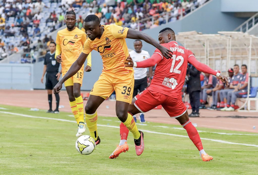 Andy Boyeli of Power Dynamos clears ball away from Shomari Kapombe of Simba during the 2023/24 CAF Champions League 1st leg match between Power Dynamos and Simba in Levy Mwanawasa Stadium, Ndola, Zambia on 16 September 2023.