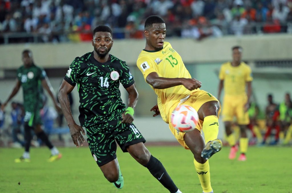 Sphephelo Sithole of South Africa challenged by Kelechi Iheanacho of Nigeria during the 2026 World Cup Qualifiers match between Nigeria and South Africa at Godswill Akpabio International Stadium.