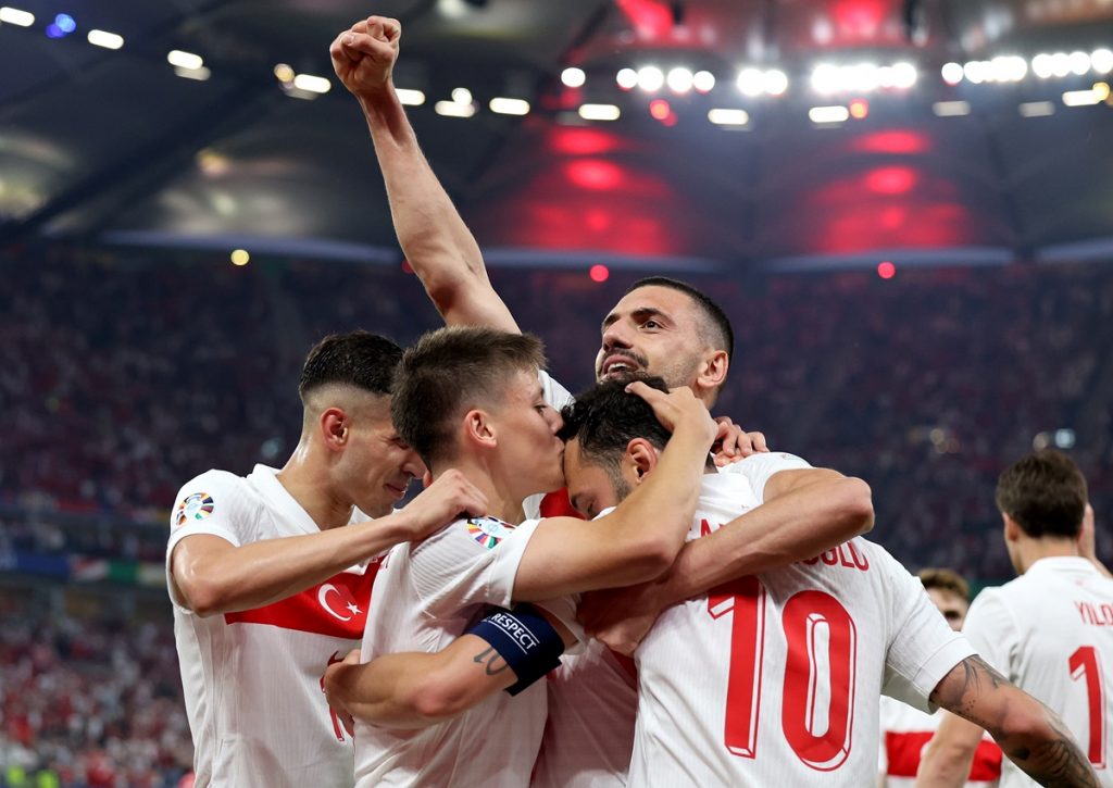 Hakan Calhanoglu (no.10) of Turkey celebrates with teammates after scoring the opening goal during the UEFA EURO 2024 group F soccer match between Czech Republic and Turkey, in Hamburg.