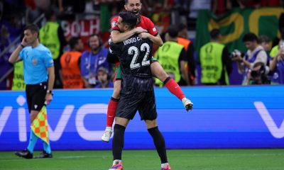 Bernardo Silva of Portugal (back) celebrates with his teammate goalkeeper Diogo Jota after scoring the third and winning penalty during the penalty shootout of the UEFA EURO 2024 Round of 16 soccer match between Portugal and Slovenia, in Frankfurt.
