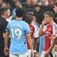 epa11619556 Referee Michael Oliver (L) shows a red card to Arsenal's Leandro Trossard (2-R) during the English Premier League match between Manchester City and Arsenal in Manchester, Britain, 22 September 2024.